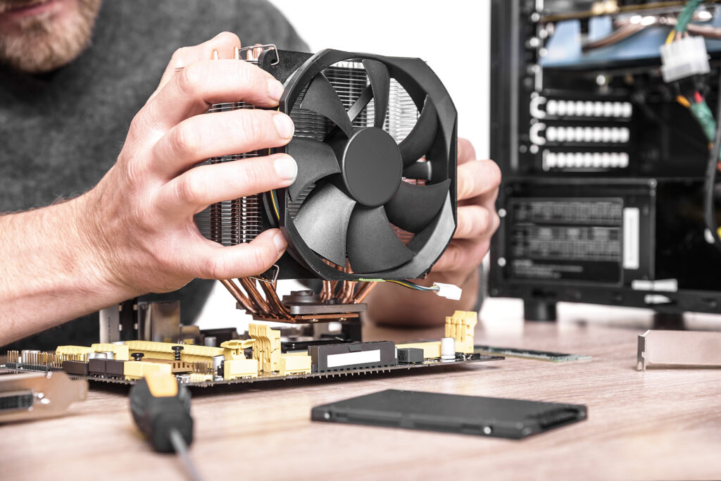 Computer technician installs cooling system